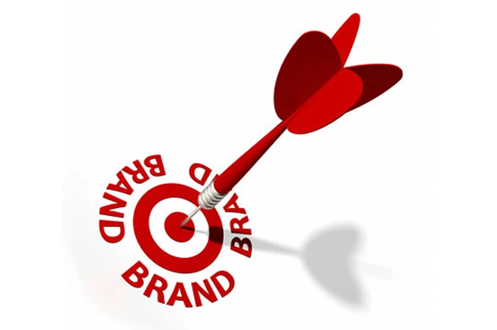 A dart centering a bullseye surrounded by the words brand forming a circle