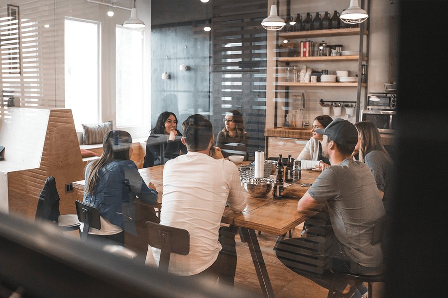 A team of workers sat round a restaurant table.