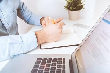 A close-up of someone working at a desk