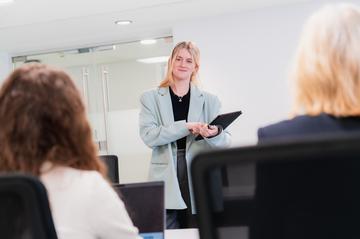 A HR Officer talks to colleagues about financial wellbeing support.