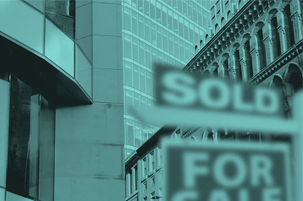 Graphic design with outside of buildings and a sold sign at the front covered in a blue hue overlay