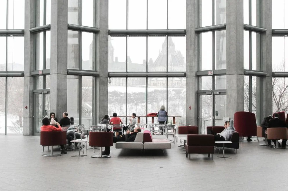 Group of people sat in small hall