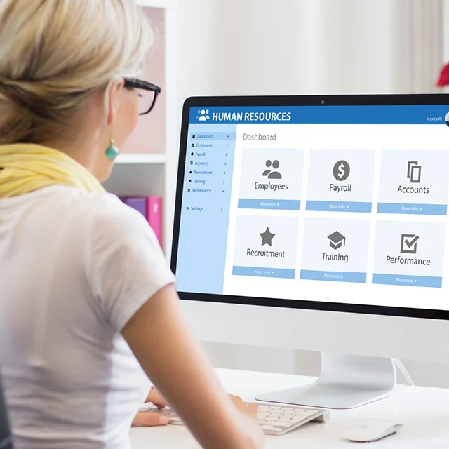 A woman sat on the desk logged in her work account.