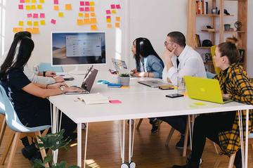 Group of people sat round a table.
