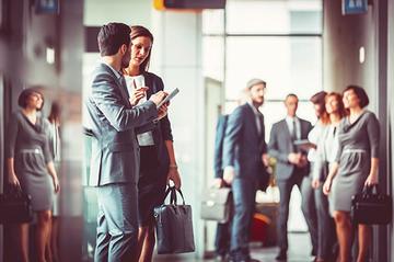 People wearing business suits and chatting