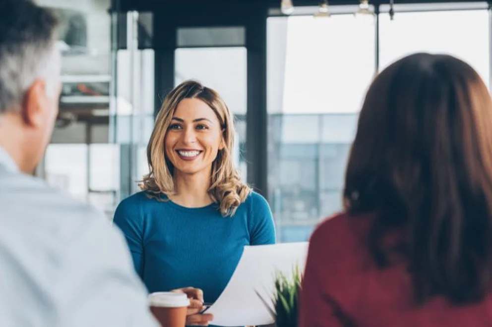 A woman having a meeting with two people