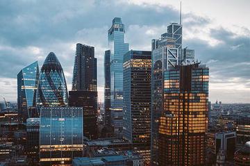 An image of the skyline in Canary Wharf at sunrise on an overcast day.