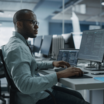 Person working with a computer sitting at a desk