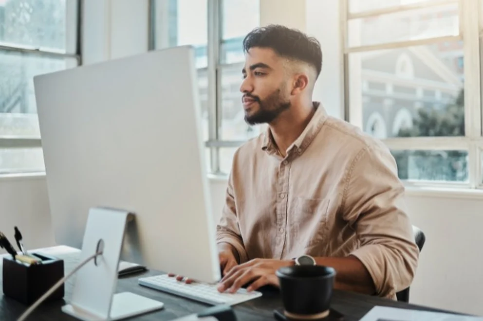 A man looking at a desktop