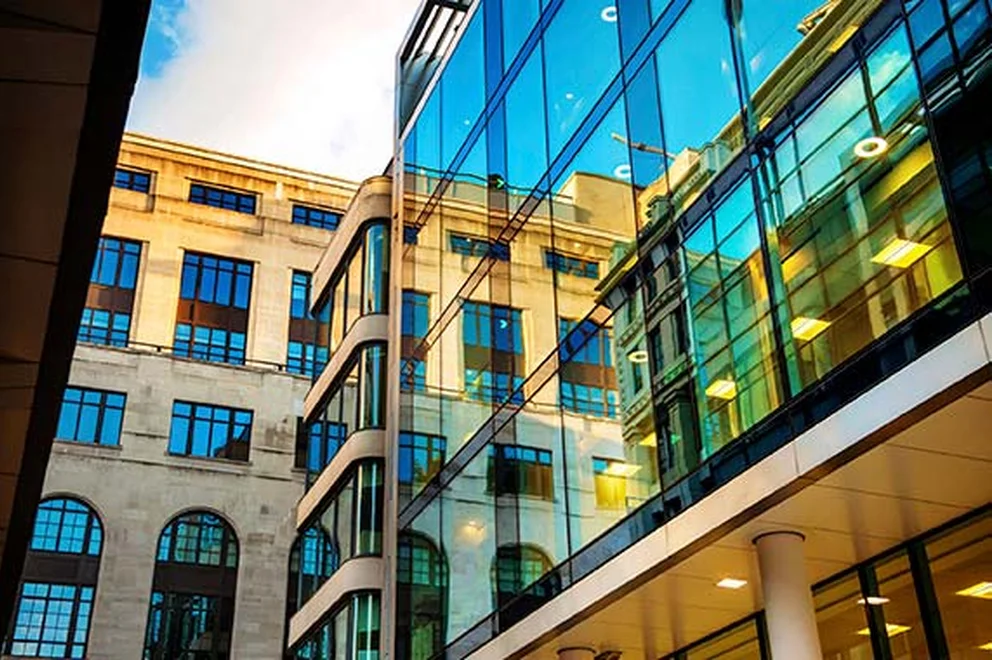 Urban setting with glass buildings and historical buildings