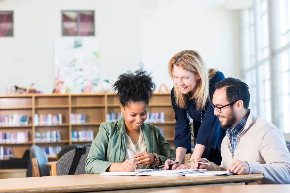 People sitting at a table and working on documents