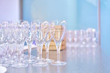 A table full of champagne flutes, waiting to be filled.