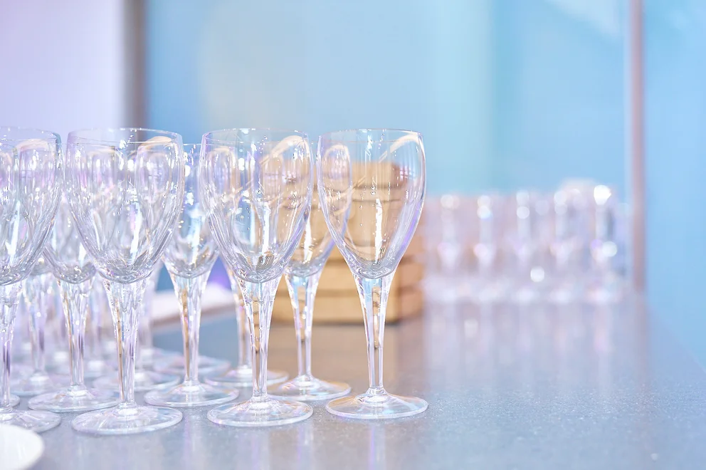A table full of champagne flutes, waiting to be filled.