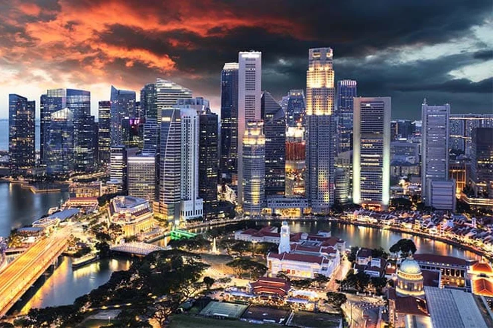 An image of the Singapore skyline and harbour at sunset.