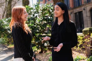 Two young lady talking to each other
