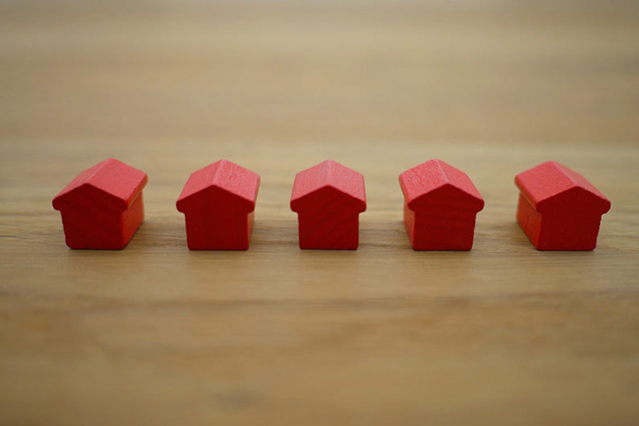 Five minature houses on a table