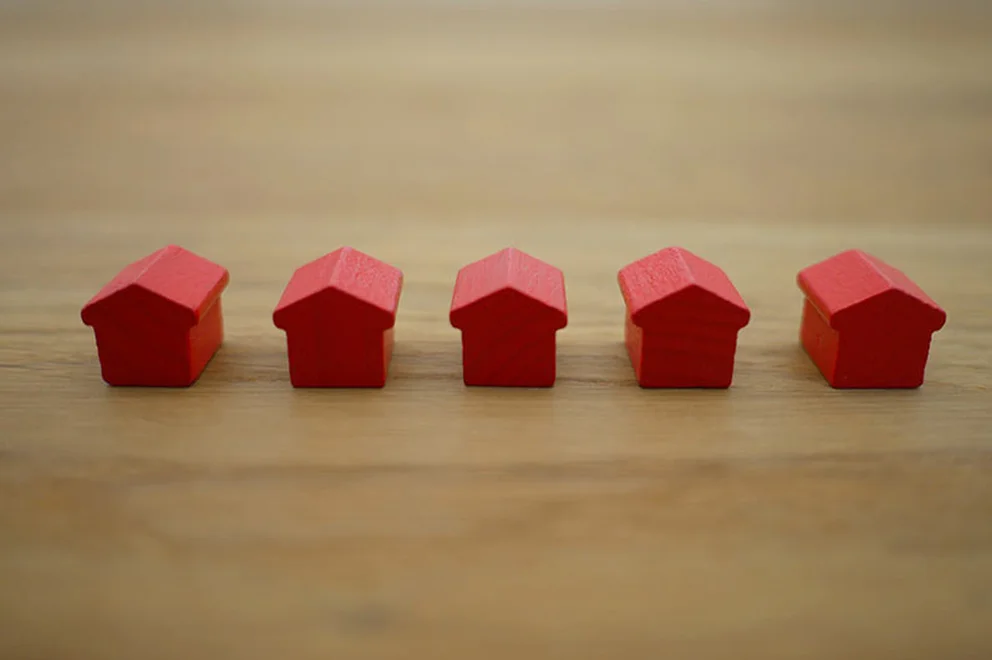 Five minature houses on a table
