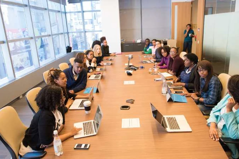 People attending a meeting in a boardroom