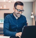 Person working with a computer sitting at a desk