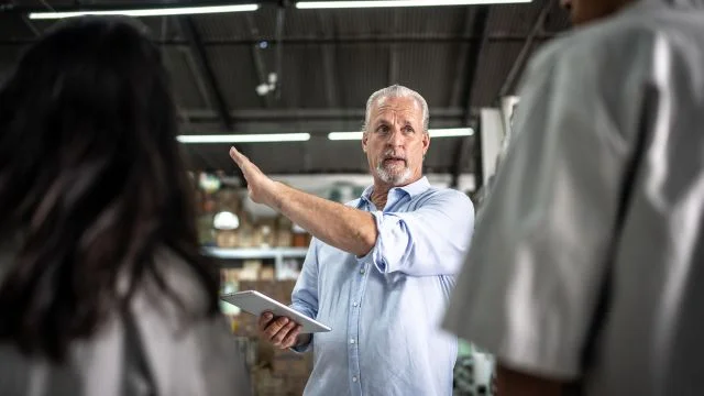 A man giving instructions to his colleagues