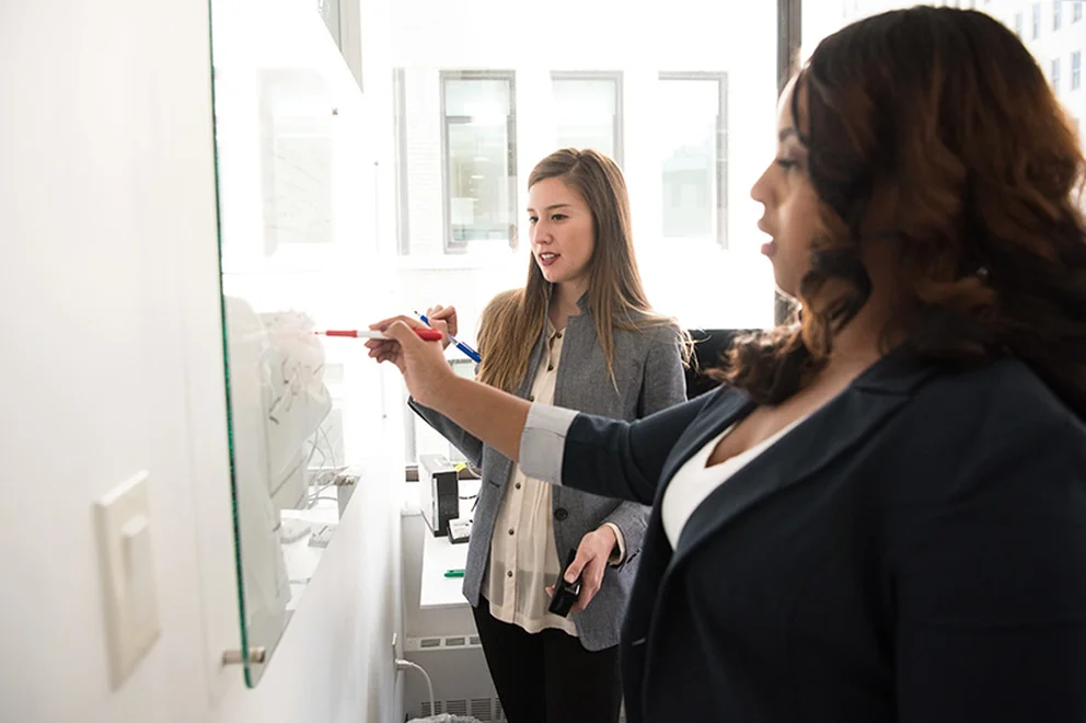 HR professionals brainstorming on a white board