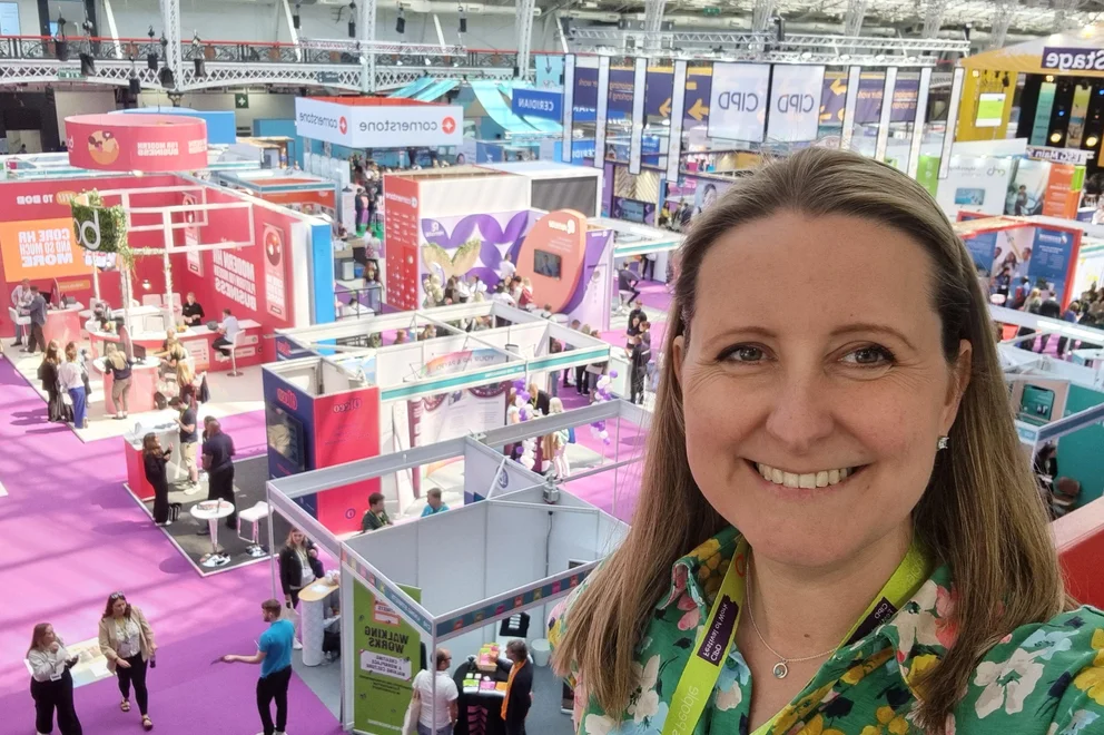 Woman posing in front of an exhibition space