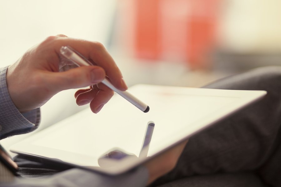 A close up of a person using a tablet.