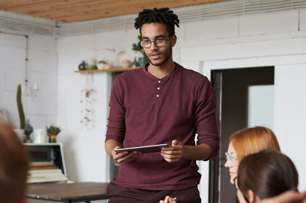 A man presenting using his tablet