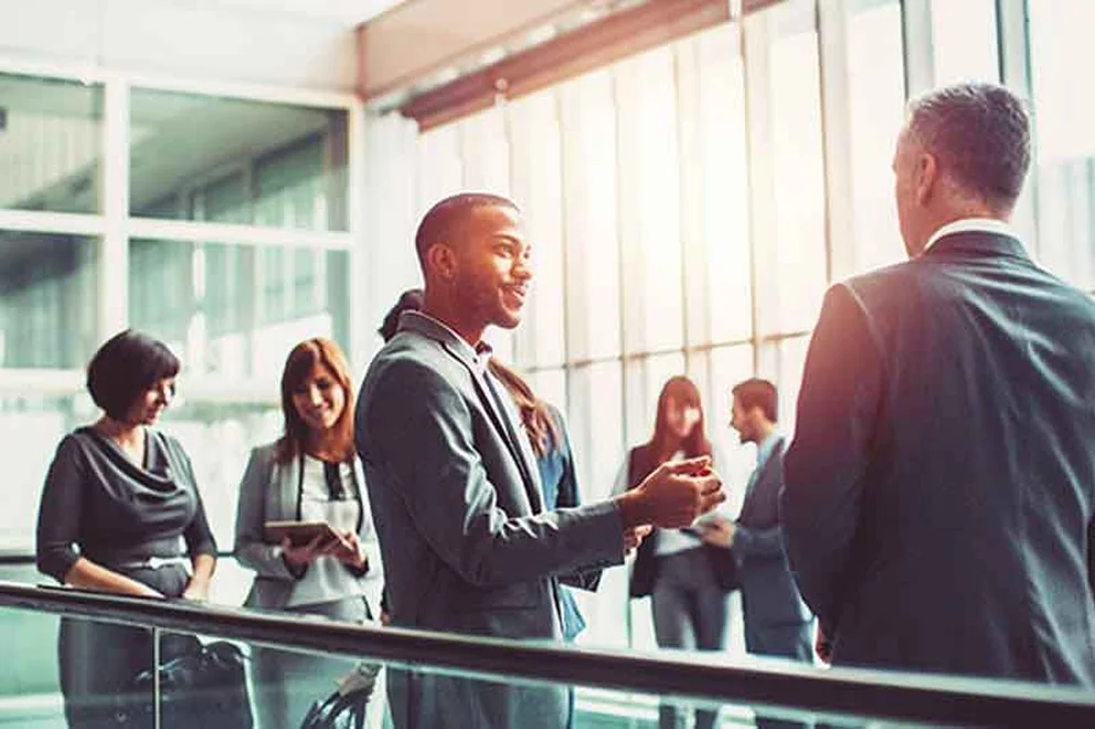 People wearing business suits and chatting