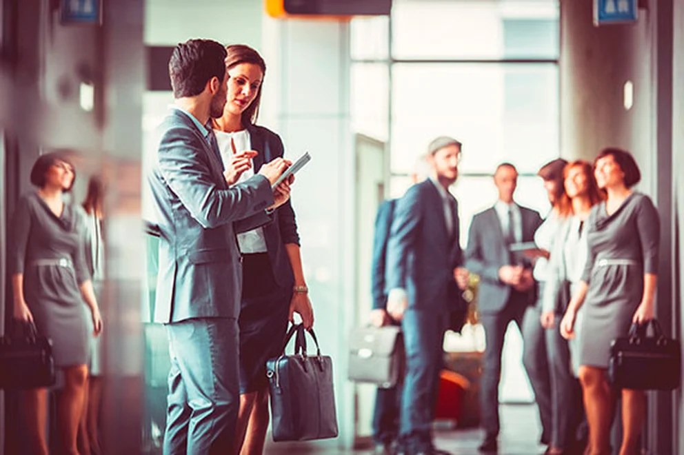 People wearing business suits and chatting