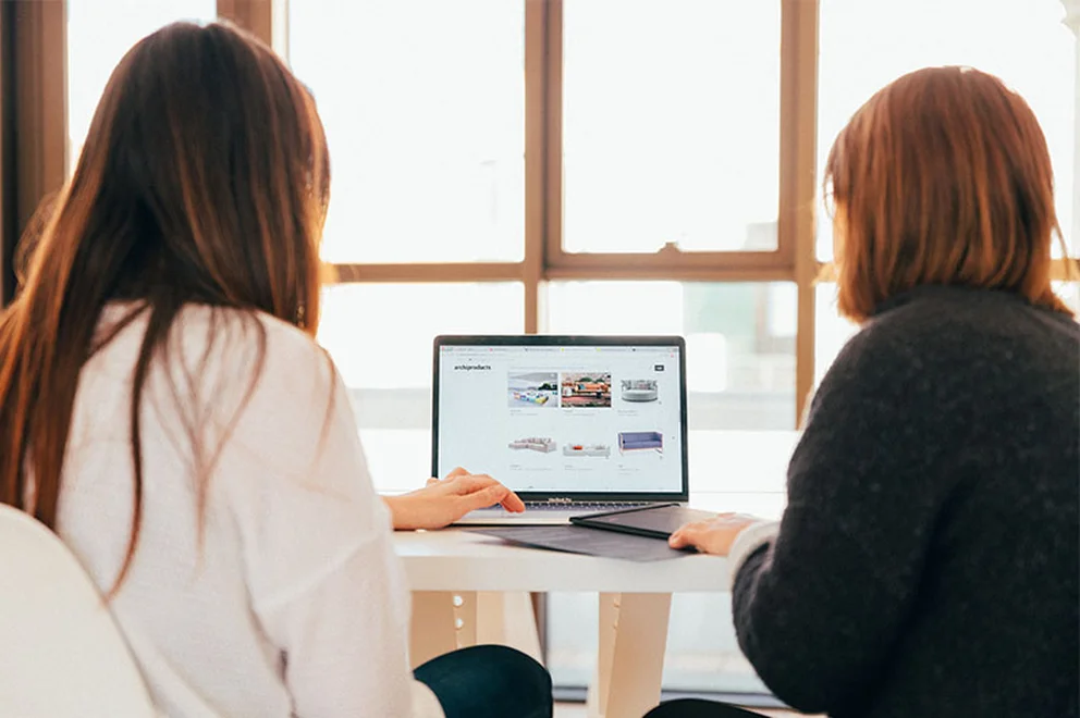 Two women looking at a laptop