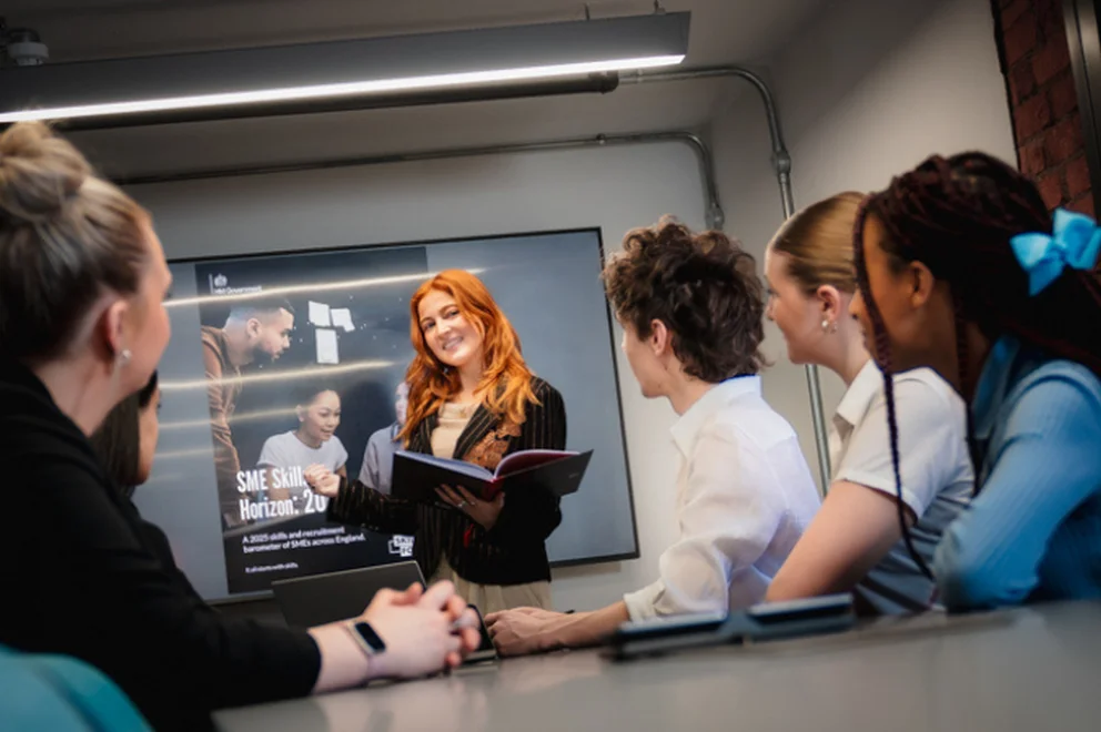 A colleague presenting a powerpoint to other colleagues