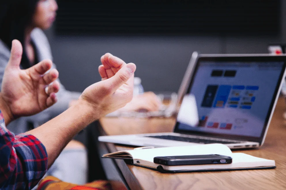 Close-up picture of hands in front of a laptop computer