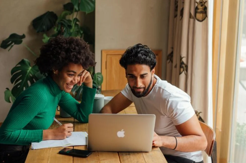 Two colleagues working together on a laptop