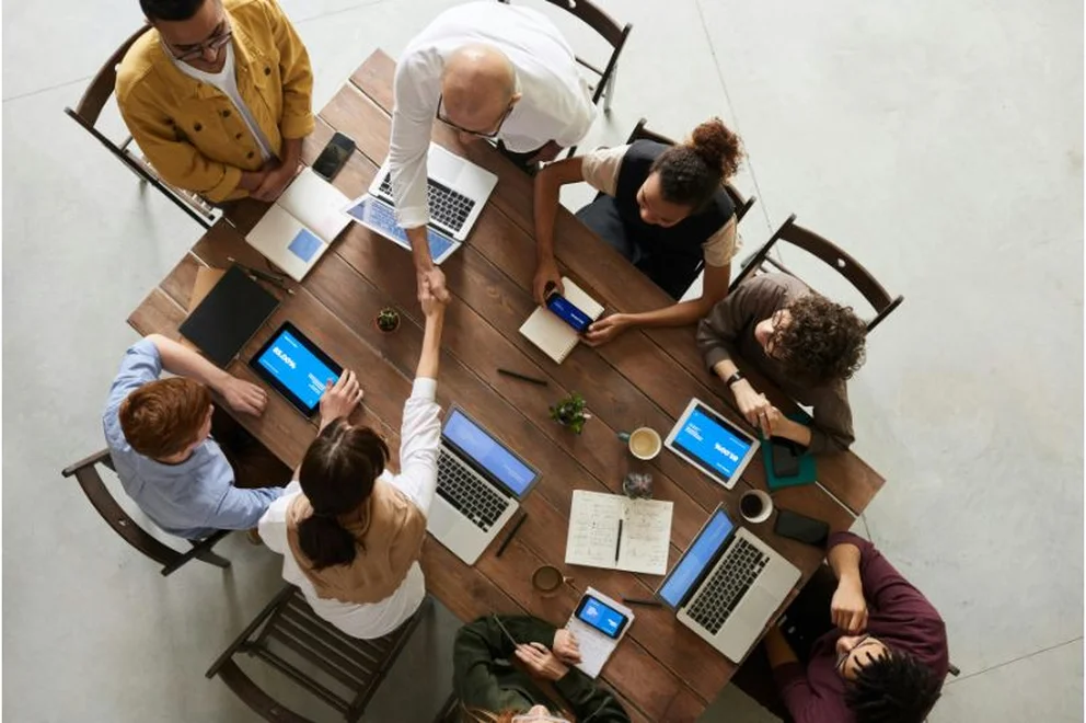 A group of people sat around a table.