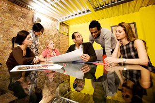 Colleagues gathered round a desk