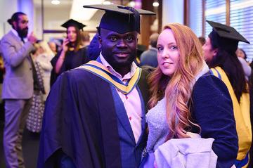 An image of Forster Amo in graduation robes at the MOL graduation.