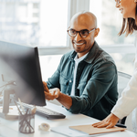Smiling person working on a laptop