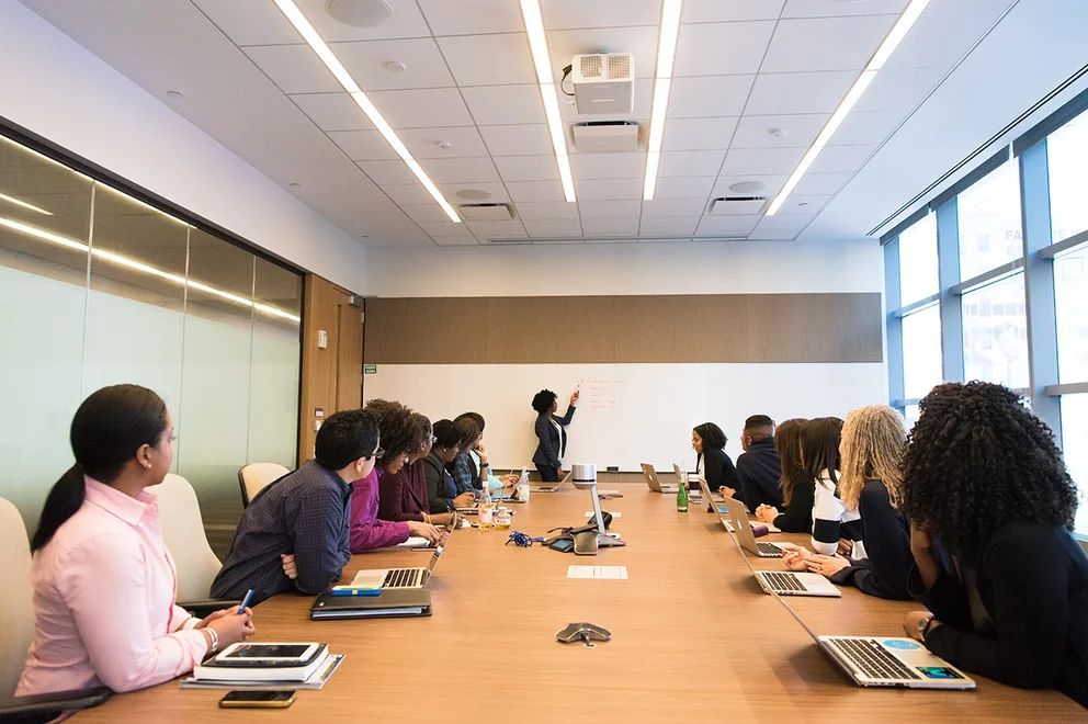 Staff sat round a boardroom table.